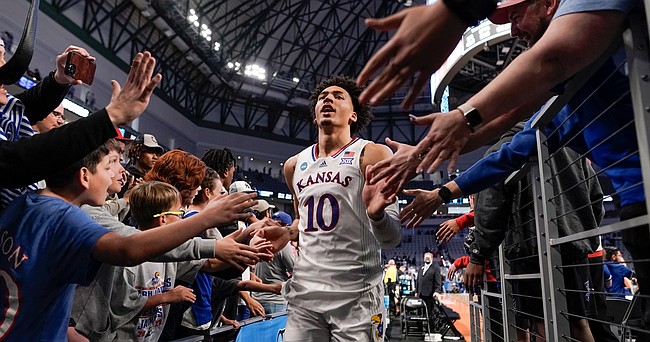 A sea of hands reach out to slap hands with Kansas forward Jalen Wilson (10) and the Jayhawks as they leave the court following their win over Creighton on Saturday, March 19, 2022 at Dickies Arena in Fort Worth, Texas. The Jayhawks advanced to the Sweet 16 with a 79-72 win over the Bluejays.