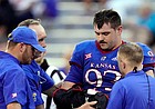 Kansas defensive lineman Sam Burt (93) is helped off the field after an injury during the first half of an NCAA college football game against South Dakota Friday, Sept. 3, 2021, in Lawrence, Kan. (AP Photo/Charlie Riedel)