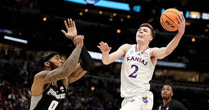Kansas guard Christian Braun (2) comes inside for a shot against Providence center Nate Watson (0) during the first half on Friday, March 25, 2022 at United Center in Chicago.