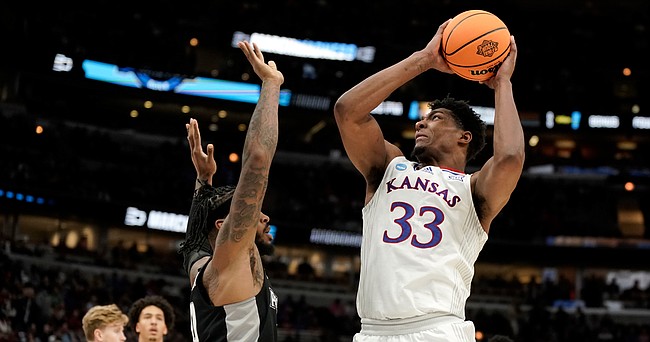 Kansas forward David McCormack (33) pulls up for a shot over Providence center Nate Watson (0) during the first half on Friday, March 25, 2022 at United Center in Chicago.