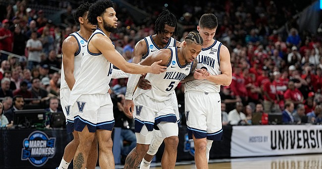 Villanova guard Justin Moore (5) is helped off the floor during the second half of a college basketball game against Houston in the Elite Eight round of the NCAA tournament on Saturday, March 26, 2022, in San Antonio. (AP Photo/David J. Phillip)