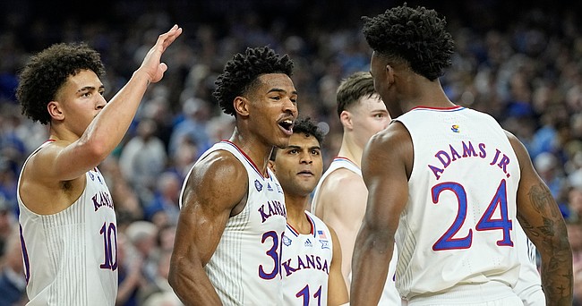 Kansas' Ochai Agbaji (30) celebrates with Jalen Wilson (10), Remy Martin (11) and K.J. Adams (24) after their win against Villanova in a college basketball game in the semifinal round of the Men's Final Four NCAA tournament, Saturday, April 2, 2022, in New Orleans. (AP Photo/David J. Phillip)


