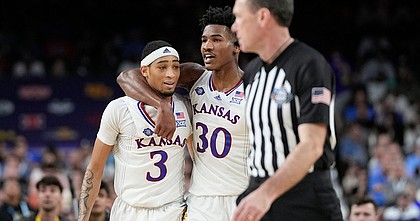 Kansas' Dajuan Harris Jr. (3) and Ochai Agbaji (30) celebrate their win over Villanova in a college basketball game in the semifinal round of the Men's Final Four NCAA tournament, Saturday, April 2, 2022, in New Orleans. (AP Photo/David J. Phillip)