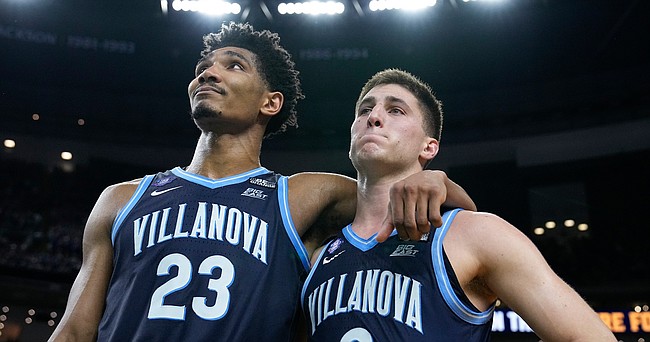 Villanova's Jermaine Samuels (23) and Collin Gillespie (2) leave the court after their loss to Kansas in a college basketball game during the semifinal round of the Men's Final Four NCAA tournament, Saturday, April 2, 2022, in New Orleans. (AP Photo/Brynn Anderson)
