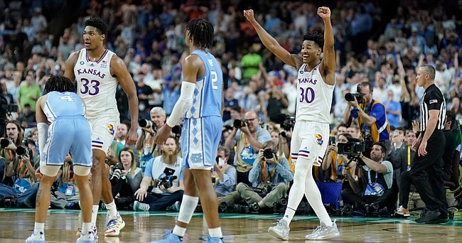 Kansas guard Ochai Agbaji (30) raises his hands as the win looks to be assured with seconds remaining in the NCAA National Championship game on Monday, April 4, 2022 at Caesars Superdome in New Orleans.