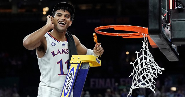 Kansas guard Remy Martin (11) looks for the applause of the crowd as the Kansas Jayhawks celebrate their 72-69 win over North Carolina in the NCAA National Championship game on Monday, April 4, 2022 at Caesars Superdome in New Orleans.