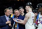 Kansas head coach Bill Self smiles as Kansas guard Christian Braun (2) jokes on the stand as the Jayhawks celebrate their 72-69 win over North Carolina in the NCAA National Championship game.