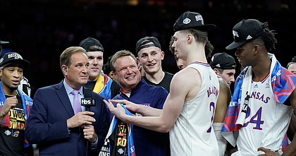Kansas head coach Bill Self smiles as Kansas guard Christian Braun (2) jokes on the stand as the Jayhawks celebrate their 72-69 win over North Carolina in the NCAA National Championship game.