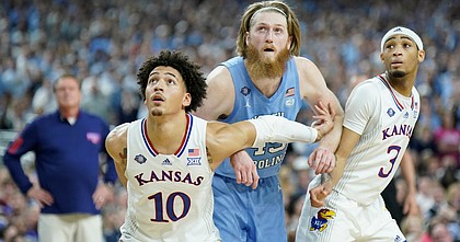 Kansas forward Jalen Wilson (10) and Kansas guard Dajuan Harris Jr. (3) box out North Carolina forward Brady Manek (45) during the first half of the NCAA National Championship game on Monday, April 4, 2022 at Caesars Superdome in New Orleans.