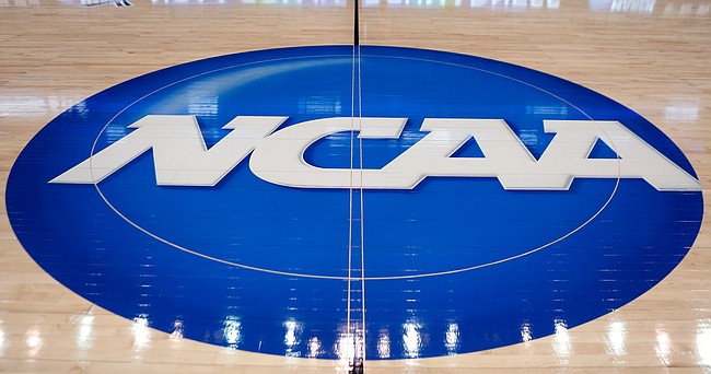 In this March 18, 2015, file photo, the NCAA logo is displayed at center court as work continues at The Consol Energy Center in Pittsburgh, for the NCAA college basketball tournament.