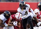 Purdue safety Marvin Grant, center, and teammate Jalen Graham tackle Nebraska wide receiver Samori Toure during a football game on Oct. 30, 2021, at Memorial Stadium in Lincoln, Neb.