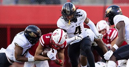 Purdue safety Marvin Grant, center, and teammate Jalen Graham tackle Nebraska wide receiver Samori Toure during a football game on Oct. 30, 2021, at Memorial Stadium in Lincoln, Neb.