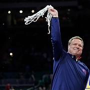 Kansas head coach Bill Self swings the final cut of the net as the Kansas Jayhawks celebrate their 72-69 win over North Carolina in the NCAA National Championship game on Monday, April 4, 2022 at Caesars Superdome in New Orleans.