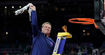 Kansas head coach Bill Self swings the final cut of the net as the Kansas Jayhawks celebrate their 72-69 win over North Carolina in the NCAA National Championship game on Monday, April 4, 2022 at Caesars Superdome in New Orleans.