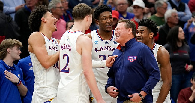Kansas head coach Bill Self laughs with several of his starters as the Jayhawks begin to celebrate their 76-50 win over Miami to advance to the Final Four.