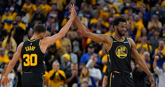 Golden State Warriors guard Stephen Curry (30) celebrates with forward Andrew Wiggins (22) during Game 5 of the NBA basketball playoffs Western Conference finals against the Dallas Mavericks in San Francisco, Thursday, May 26, 2022. (AP Photo/Jeff Chiu)


