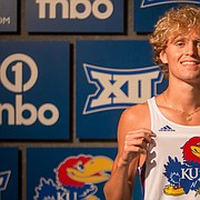 Lawrence's Tanner Newkirk shows off his future uniform during his visit to the University of Kansas, where he signed to run cross country and track starting in the fall of 2022. 