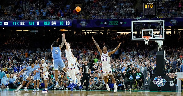 Kansas guard Christian Braun (2) and Kansas forward KJ Adams (24) defend a final shot from North Carolina guard Caleb Love (2) that missed giving the Jayhawks a 72-69 win over the Tar Heels in the NCAA National Championship game on Monday, April 4, 2022 at Caesars Superdome in New Orleans.