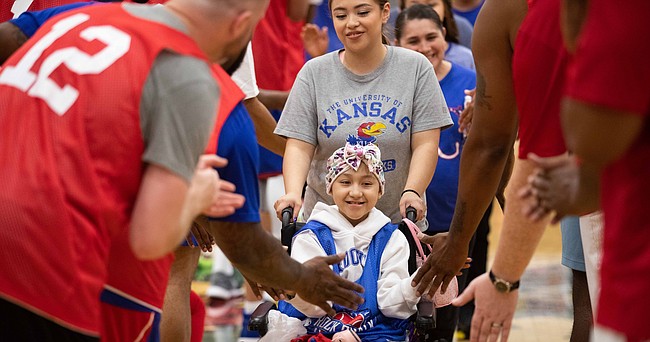 Fatima Gomez, a member of the 2022 Starting Five at The Rock Chalk Roundball Classic, makes her way through player introductions at Free State High School on Thursday, June 9, 2022.
