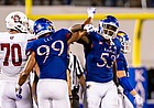 Kansas defensive linemen Caleb Taylor, right, and Malcolm Lee celebrate after making a play in the Week 1 win over South Dakota on Sept. 3, 2021, at David Booth Kansas Memorial Stadium.