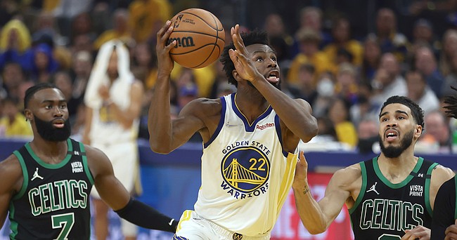 Golden State Warriors forward Andrew Wiggins (22) shoots against Boston Celtics guard Jaylen Brown (7) and forward Jayson Tatum (0) during the first half of Game 5 of basketball's NBA Finals in San Francisco, Monday, June 13, 2022. (AP Photo/Jed Jacobsohn)


