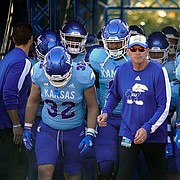 Kansas head coach Lance Leipold runs onto the field with his team prior to a college football game against Texas Tech on Oct. 16, 2021, in Lawrence.