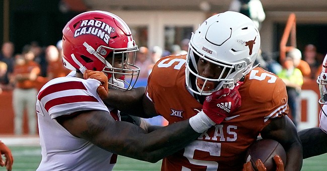 Texas' Bijan Robinson is hit by Louisiana's Lorenzo McCaskill during the second half of game on Sept. 4, 2021, in Austin, Texas.