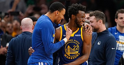 Golden State Warriors forward Andrew Wiggins (22) celebrates with forward Otto Porter Jr. (32) as time winds down against the Boston Celtics in Game 6 of basketball's NBA Finals, Thursday, June 16, 2022, in Boston. (AP Photo/Steven Senne)


