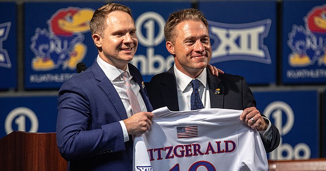 Kansas athletic director Travis Goff, left, and baseball coach Dan Fitzgerald speak at a news conference introducing Fitzgerald on June 16, 2022.