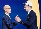 Christian Braun, right, is congratulated by NBA commissioner Adam Silver after being selected 21st by the Denver Nuggets in the NBA Draft on June 23, 2022, in New York.