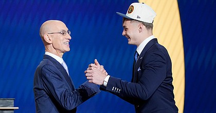 Christian Braun, right, is congratulated by NBA commissioner Adam Silver after being selected 21st by the Denver Nuggets in the NBA Draft on June 23, 2022, in New York.
