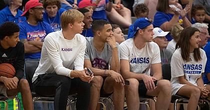 Current Kansas Men's Basketball players, Gradey Dick, third from left, Kevin McCullar Jr. and Michael Jankovich, came out to watch the 14th annual Rock Chalk Roundball Classic at Free State High School on Thursday, June 9, 2022.