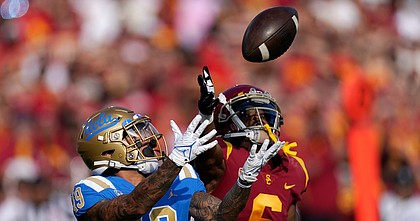 UCLA running back Kazmeir Allen, left, makes a touchdown catch as USC cornerback Isaac Taylor-Stuart defends during the first half of a game on Nov. 20, 2021, in Los Angeles.