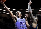 Kansas State guard Nijel Pack drives past West Virginia forward Isaiah Cottrell during game in Manhattan, Kan., on Feb. 14, 2022. Pack made one of the first big splashes of the NIL era when he received a six-figure endorsement deal shortly after transferring to Miami in April.
