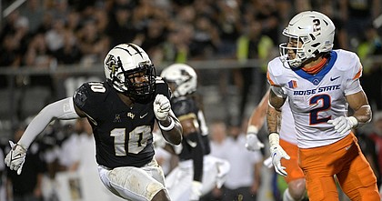 Boise State wide receiver Khalil Shakir runs in front of UCF linebacker Eriq Gilyard during a game on Sept. 2, 2021, in Orlando, Fla.