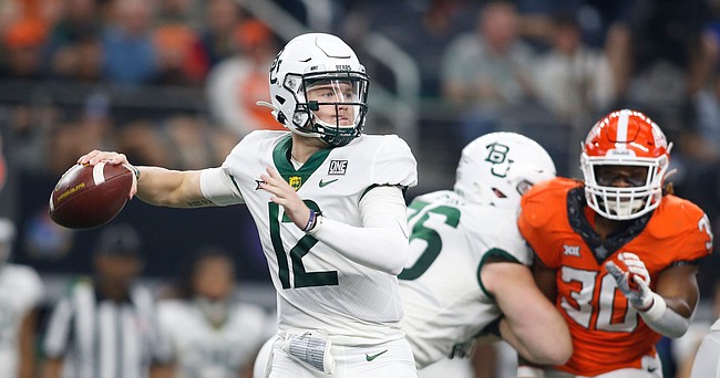 Baylor quarterback Blake Shapen looks to pass as Oklahoma State defensive end Collin Oliver pursues him in the second half of the Big 12 championship game in Arlington, Texas, on Dec. 4, 2021.