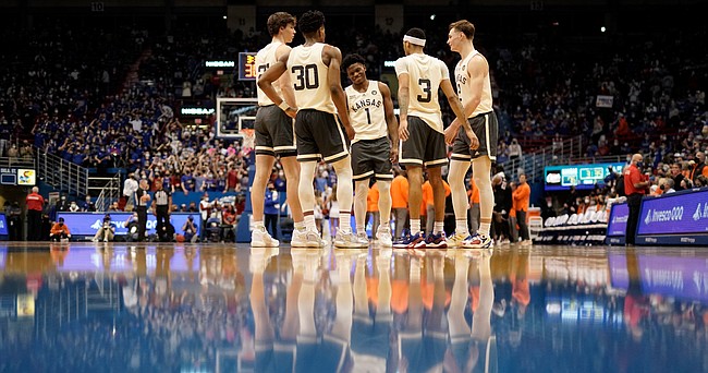 Kansas players huddle together during a break in action in the second half on Monday, Feb. 14, 2022 at Allen Fieldhouse.