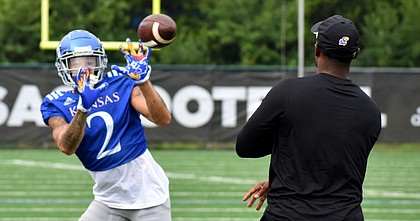 Kansas wide receiver Lawrence "LJ" Arnold catches a pass as part of a drill during a training camp practice on Aug. 8, 2022.