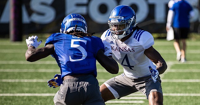 Kansas safety Marvin Grant Jr., right, defends wide receiver Doug Emilien during a training camp practice on Aug. 9, 2022.