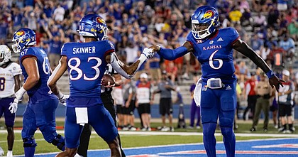 Kansas quarterback Jalon Daniels (6) bumps fists with Kansas wide receiver Quentin Skinner (83) after running in a touchdown during the first quarter on Friday, Sept. 2, 2022 at Memorial Stadium.