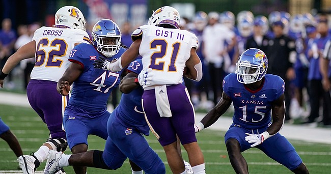 Kansas defensive end Lonnie Phelps (47) closes in on Tennessee Tech running back David Gist (21) with Kansas linebacker Craig Young (15) and Kansas defensive lineman Caleb Taylor (53) during the first quarter on Friday, Sept. 2, 2022 at Memorial Stadium.