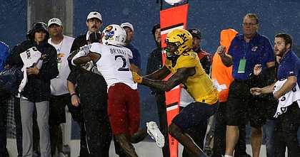 Kansas cornerback Cobee Bryant (2) intercepts a pass intended for West Virginia wide receiver Bryce Ford-Wheaton (0) during overtime of an NCAA college football game in Morgantown, W.Va., Saturday, Sept. 10, 2022. (AP Photo/Kathleen Batten)



