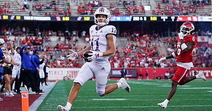 Kansas wide receiver Luke Grimm (11) runs in to the end zone for a touchdown during the first half of an NCAA college football game against Houston, Saturday, Sept. 17, 2022, in Houston. (AP Photo/Eric Christian Smith)