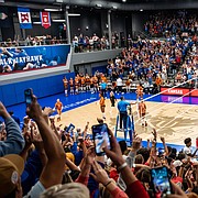 The Kansas volleyball team, and the Horejsi Family Volleyball Arena crowd, explode at the end of set No. 2 after the Jayhawks' 25-23 win over No. 1 Texas gave KU a two-sets-to-none lead in the match. Texas came back to win the match in five sets, marking the second straight season that the Longhorns came from two sets down to defeat Kansas in Lawrence. 