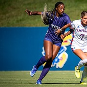 Sophomore midfielder Raena Childers (7) fights to push the ball up the field as a TCU player closes in during the Jayhawks' 1-0 loss to the Horned Frogs on Sunday, Sept. 25, 2022 at Rock Chalk Park. 