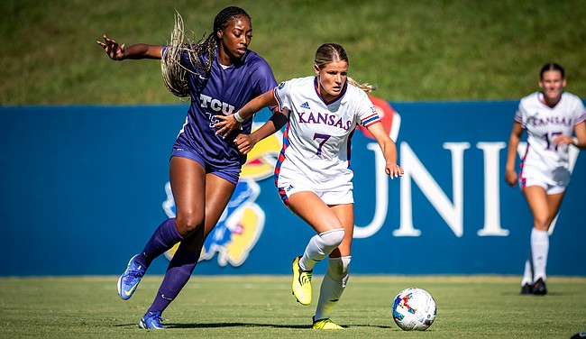 Sophomore midfielder Raena Childers (7) fights to push the ball up the field as a TCU player closes in during the Jayhawks' 1-0 loss to the Horned Frogs on Sunday, Sept. 25, 2022 at Rock Chalk Park. 