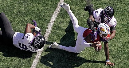 Kansas quarterback Jalon Daniels is sacked by TCU linebacker Jamoi Hodge during the first half of a game on Oct. 8, 2022, in Lawrence, Kan.