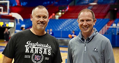 Kansas women's basketball coach Brandon Schneider, left, is pictured here with new play-by-play voice of KU women's basketball, Steven Davis, at a recent practice at Allen Fieldhouse. 