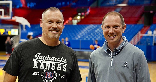 Kansas women's basketball coach Brandon Schneider, left, is pictured here with new play-by-play voice of KU women's basketball, Steven Davis, at a recent practice at Allen Fieldhouse. 