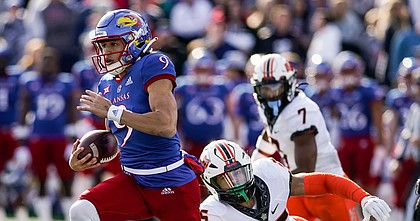 Kansas quarterback Jason Bean gets past Oklahoma State safety Jason Taylor II (25) on his way to a touchdown during the second quarter on Saturday, Nov. 5, 2022 at Memorial Stadium.
